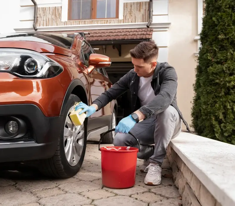 Lavage auto à domicile Saint-Germain-la-Blanche-Herbe : professionnel intervenant sur un véhicule